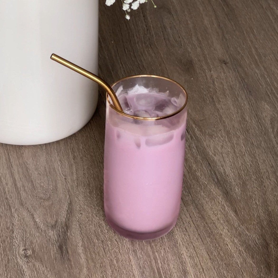 a glass of Purple matcha latte iced